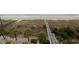 Stunning aerial view of boardwalk and palm trees leading to a pristine, sandy beach at 1903 S Ocean Blvd. # 606, North Myrtle Beach, SC 29582