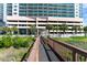 Exterior of the building with well manicured landscape and an elevated wooden walkway to the beach at 1903 S Ocean Blvd. # 606, North Myrtle Beach, SC 29582