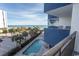 Balcony view of the ocean, palm trees, and a swimming pool, showcasing a serene coastal living experience at 2001 S Ocean Blvd. # 418, Myrtle Beach, SC 29577