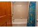 Cozy bathroom with a tiled shower/tub and a vibrant shower curtain featuring an ocean life theme at 2001 S Ocean Blvd. # 418, Myrtle Beach, SC 29577