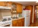 Kitchen featuring wood cabinets, white appliances, and a window at 2001 S Ocean Blvd. # 418, Myrtle Beach, SC 29577