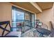 Balcony with ocean view visible through sliding glass doors, complemented by cozy seating and area rug at 201 75Th Ave N # 4094, Myrtle Beach, SC 29572