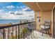 A balcony with seating and a view of the ocean and surrounding buildings under a cloudy sky at 201 75Th Ave N # 4094, Myrtle Beach, SC 29572