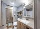 Bathroom featuring gray walls, wood-look floors, a sink, toilet, and view to the tub/shower combo at 201 75Th Ave N # 4094, Myrtle Beach, SC 29572