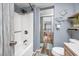 Bathroom featuring a tub/shower combo, gray walls, wood-look floors, and views into living space beyond at 201 75Th Ave N # 4094, Myrtle Beach, SC 29572