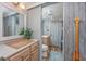 Bright bathroom featuring wood-like flooring, a vessel sink, and a decorative paddle adorning the wall at 201 75Th Ave N # 4094, Myrtle Beach, SC 29572