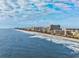 Expansive beach scene featuring high-rise hotels and the calming ocean at 201 75Th Ave N # 4094, Myrtle Beach, SC 29572