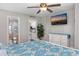 Bedroom features ceiling fan, wood-look floors, a mounted TV, and adjacent bathroom and kitchen at 201 75Th Ave N # 4094, Myrtle Beach, SC 29572