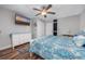 Bedroom features ceiling fan, wood-look floors, a mounted TV, and white bedroom furniture at 201 75Th Ave N # 4094, Myrtle Beach, SC 29572