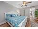 Bedroom with white trim, wood-look floors, and a bed with blue patterned bedding at 201 75Th Ave N # 4094, Myrtle Beach, SC 29572