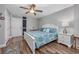 Bedroom with ceiling fan, wood-look floors, white trim, and a bed with blue patterned bedding at 201 75Th Ave N # 4094, Myrtle Beach, SC 29572