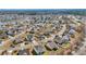 Aerial view showcasing a residential neighborhood with a pond and a mix of home styles and mature trees at 228 Gresham Ln., Myrtle Beach, SC 29588