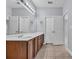 Bathroom featuring double sink vanity with wood cabinets and tile flooring at 228 Gresham Ln., Myrtle Beach, SC 29588