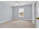 A serene bedroom with carpet flooring, a window, ceiling fan, and gray walls at 228 Gresham Ln., Myrtle Beach, SC 29588