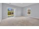 Bright bedroom with carpet flooring, a window, and sliding glass doors to the outside at 228 Gresham Ln., Myrtle Beach, SC 29588