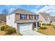 A two-story home showcases a brick and siding facade, two-car garage, and well-kept lawn at 228 Gresham Ln., Myrtle Beach, SC 29588