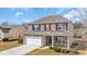 Brick-fronted two-story home with a two-car garage and well-manicured lawn at 228 Gresham Ln., Myrtle Beach, SC 29588