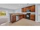 Open kitchen featuring wood cabinets, tile flooring, stainless steel dishwasher, and black oven at 228 Gresham Ln., Myrtle Beach, SC 29588