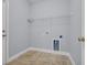 A well-lit laundry room with tile floor, white wire shelving, and gray walls at 228 Gresham Ln., Myrtle Beach, SC 29588