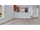 Open living room featuring neutral walls and carpet, with a view of the kitchen at 228 Gresham Ln., Myrtle Beach, SC 29588