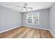 Bright bedroom featuring wood-look floors, a ceiling fan, and natural light from a window at 229 Duchess Ct., Myrtle Beach, SC 29588