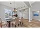 Dining room with modern chandelier, glass table, and large windows with bright natural light at 229 Duchess Ct., Myrtle Beach, SC 29588