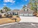 Charming brick home featuring a three-car garage and beautifully landscaped front yard at 229 Duchess Ct., Myrtle Beach, SC 29588