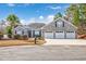 Charming single-Gathering home featuring a brick facade, manicured lawn, and a three-car garage at 229 Duchess Ct., Myrtle Beach, SC 29588