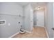 Neutral laundry room features storage shelves, tile floors, and access to the front entrance at 229 Duchess Ct., Myrtle Beach, SC 29588