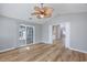 Bright living room with modern wood floors, a ceiling fan, and sliding door to an enclosed porch at 229 Duchess Ct., Myrtle Beach, SC 29588