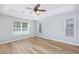 Main bedroom featuring wood floors, a tray ceiling, and lots of natural light at 229 Duchess Ct., Myrtle Beach, SC 29588