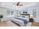 Spacious main bedroom with a tray ceiling, a ceiling fan, and large windows at 229 Duchess Ct., Myrtle Beach, SC 29588