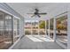 Enclosed screened porch features neutral walls, ceiling fan and an entrance with a view to outdoors at 229 Duchess Ct., Myrtle Beach, SC 29588