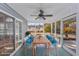 Relaxing screened porch with dining table, ceiling fan, and views of the landscaped yard at 229 Duchess Ct., Myrtle Beach, SC 29588