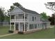 Inviting two-story home featuring a charming double-decker porch and classic architectural design at 237 Madison Dr., Georgetown, SC 29440