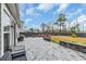 View of the paved patio with a built-in outdoor kitchen, a fire pit area with seating, and a fenced yard at 2593 Pegasus Place, Myrtle Beach, SC 29577