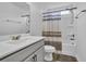 Bright bathroom featuring a shower-tub combo with a striped curtain, a vanity with mirror, and towel racks at 2593 Pegasus Place, Myrtle Beach, SC 29577