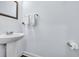 Bathroom with a pedestal sink, wall mirror, and wall-mounted towel rack in a neutrally painted room at 2593 Pegasus Place, Myrtle Beach, SC 29577