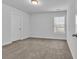 Neutral bedroom featuring light gray walls, natural light, and soft carpeting at 2593 Pegasus Place, Myrtle Beach, SC 29577