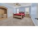 Stylish blue bedroom with a ceiling fan, carpet, and a bed between two windows at 2593 Pegasus Place, Myrtle Beach, SC 29577