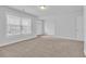 Spacious room with plush carpeting, a window with blinds, light fixtures and an entrance to another room at 2593 Pegasus Place, Myrtle Beach, SC 29577