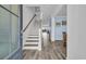 Inviting entryway showcasing hardwood floors, a staircase with wooden railing, and a view into the dining area at 2593 Pegasus Place, Myrtle Beach, SC 29577