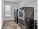 Laundry room with tile floors, a window and modern washer and dryer at 2593 Pegasus Place, Myrtle Beach, SC 29577