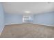 Spacious living room with neutral carpet and calming blue walls is ready for your personal touches at 2593 Pegasus Place, Myrtle Beach, SC 29577