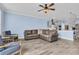 Spacious living area showcasing an open floor plan with a comfortable leather sofa and stylish accent chairs at 2593 Pegasus Place, Myrtle Beach, SC 29577