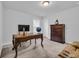 Well-lit home office with an ornate desk, dresser and carpeted floors at 2593 Pegasus Place, Myrtle Beach, SC 29577