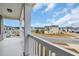 View from porch shows white vinyl railing, gray siding, and a quaint neighborhood with blue sky at 2593 Pegasus Place, Myrtle Beach, SC 29577