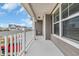 View of a porch with white railing, gray vinyl siding, and view of a quaint neighborhood at 2593 Pegasus Place, Myrtle Beach, SC 29577