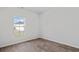 Bright bedroom with wood-look floors and a window view of the home across the street at 272 Warner Crossing Way, Loris, SC 29569