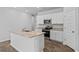 Spacious kitchen featuring white cabinets, island with sink, granite countertops, and stainless steel appliances at 272 Warner Crossing Way, Loris, SC 29569